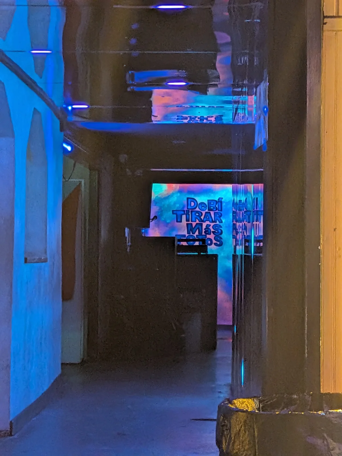 Night scene in La Placita — blue neon lighting