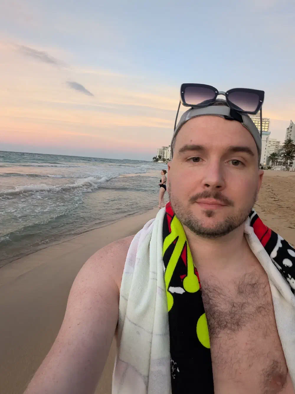 Standing at the water's edge at sunset