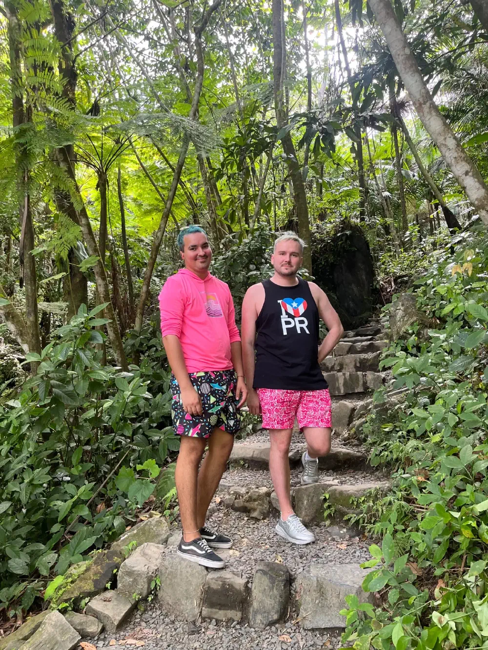 Two men pausing on stone steps deep in the jungle