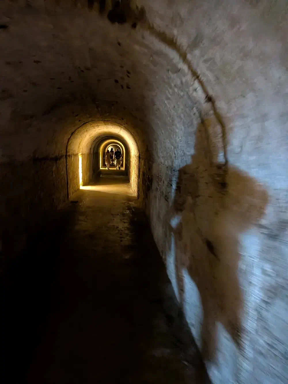 Fort tunnel — stone arches leading to the light